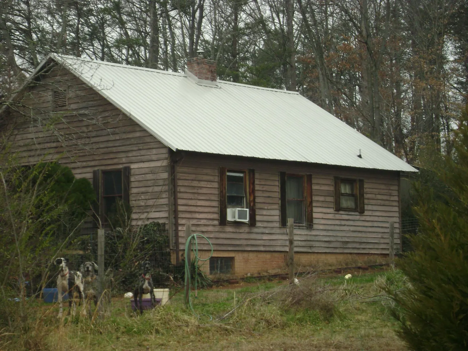 White metal roof on an old wood sided farmhouse, from a Metal Roof Installation job in Freeland